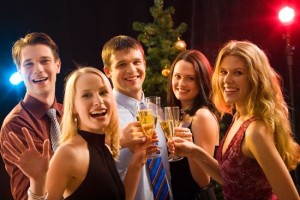 Smiling group of young people enjoying cocktails at christmas